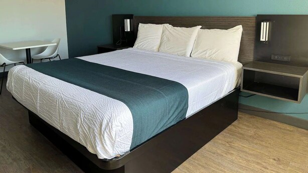 A modern hotel room with a large bed, a desk, and a chair. - Modern Room w/ Free Parking | Redondo Beach Station - 3 miles away (Gardena)