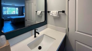 A bathroom with a white sink, black faucet, and a mirror. There is a towel rack with two towels. - Modern Room w/ Free Parking | Redondo Beach Station - 3 miles away (Gardena)