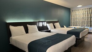 A hotel room with two beds, dark headboards, and a small table. - Value Stay | Room w/ Free Parking | 3 Miles from South Bay Galleria (Gardena)