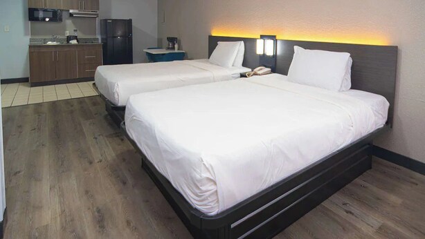A hotel room with two beds, a kitchenette, and a small bathroom. - 2 West Palm Units w/ Kitchen | 3 Miles to Downtown West Palm | Free Parking (West Palm Beach)