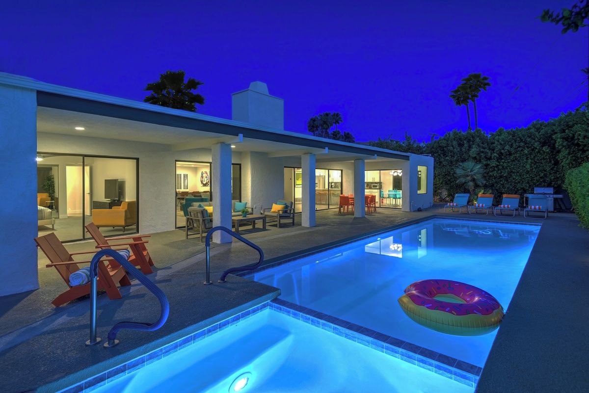 A swimming pool with lounge chairs and a poolside area.