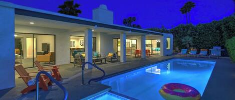 A swimming pool with lounge chairs and a poolside area.