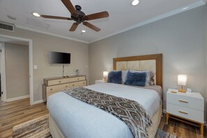 A bedroom with a bed, a nightstand, a TV, and a ceiling fan. - Vista Ranch Hideaway: Palm Springs Home with Private Pool and Mountain Views (Palm Springs)
