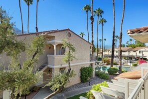 A hotel with a pool, palm trees, and a mountain in the background. - Mesquite WorkPlay Oasis - Central PS (Palm Springs)