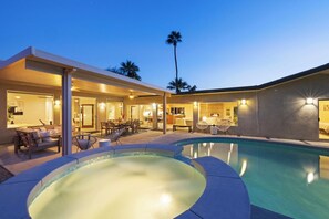 A modern house with a swimming pool, outdoor seating, and a covered patio area. - Mountain Views Luxury Oasis: Pool, Hot Tub, BBQ (Palm Springs)