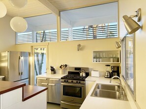 A modern kitchen with stainless steel appliances, a gas stove, and a built-in oven. - Retro Rendezvous - South PS (Palm Springs)