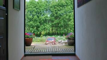 A hallway with a view of a forested area outside.