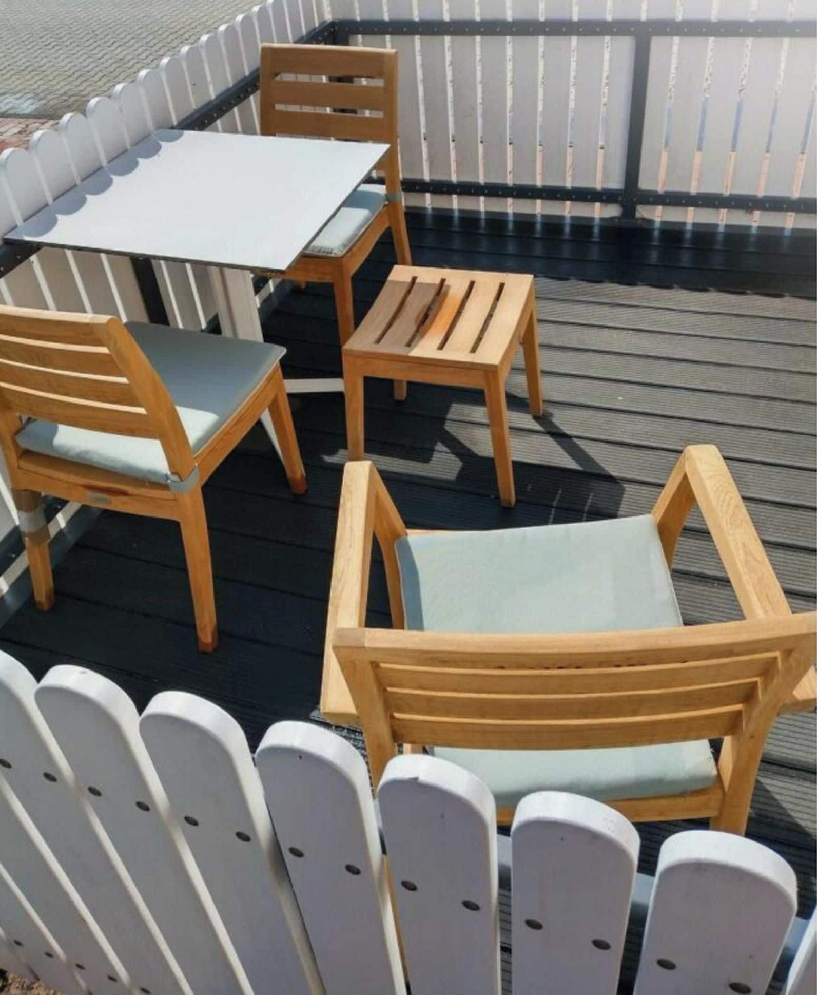 A deck with a table and four chairs.