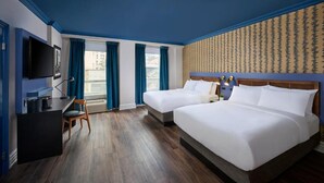 A hotel room with two beds, a desk, a television, and a window with curtains. - Market Square Boutique Hotel (Toronto)