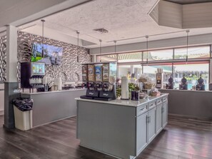 A modern coffee shop interior with a counter, coffee machines, and a large window. - King Studio -waterfront views from private balcony with boat dock. (Sarasota)