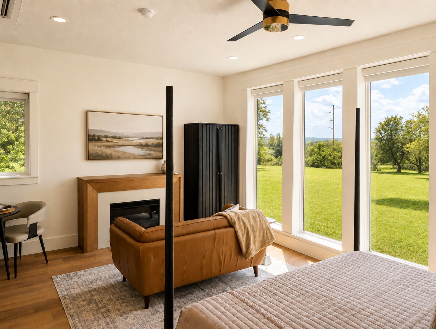 Ein modernes Schlafzimmer mit Kamin, einer Couch, einem Bett und einem großen Fenster mit Blick auf eine grüne Landschaft.