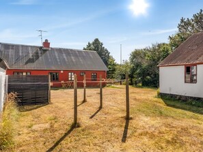 A rural property with a red barn, a white building, and a fenced area with wooden posts. - "Safir" - 1.7km from the sea by Interhome (Snedsted)