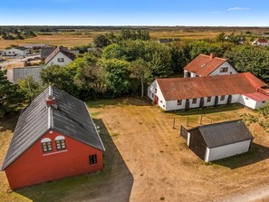 A rural property with a red barn, white buildings, and a fenced yard. - "Safir" - 1.7km from the sea by Interhome (Snedsted)
