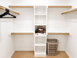 A closet with wooden hangers, shelves, and a laundry basket. - 3BR Near Fort Cavazos | TDY • PCS • Extended Stay (Killeen)