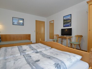 A bedroom with a bed, a desk with a chair, a television, and two paintings on the wall. - House with last ski descent around the corner (Wagrain)