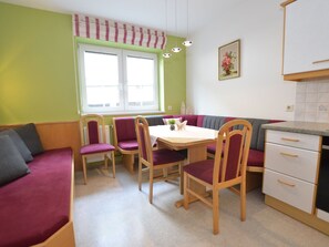 A compact kitchen with a dining area, featuring a table, chairs, and a bench. - House with last ski descent around the corner (Wagrain)