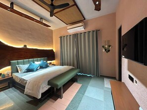 A bedroom with a bed, bench, curtains, and a TV. - Nook & Corner - A Peaceful 2-bedroom bed & breakfast with AC for a relaxing stay (Unknown)