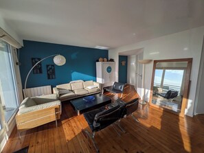 A modern living room with a sofa, chairs, a coffee table, and a cabinet. - Perfect 3-bedroom 2 bathroom apartment right on the waterfront (Wimereux)