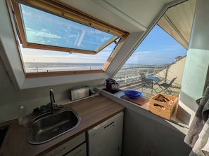 A compact kitchen with a skylight, a sink, and a small dishwasher. - Perfect 3-bedroom 2 bathroom apartment right on the waterfront (Wimereux)