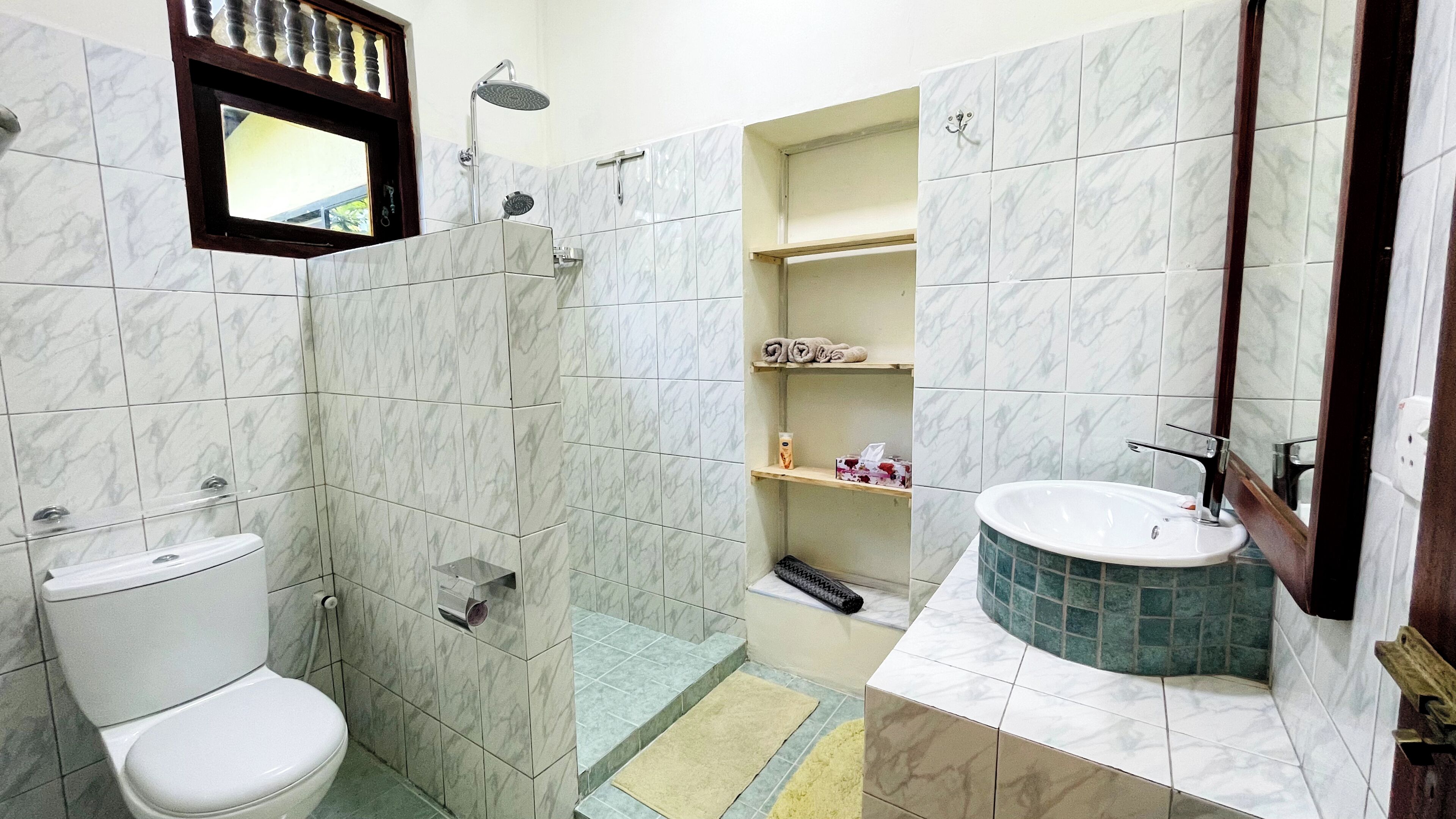 A bathroom with a toilet, a shower, a sink, and a bathtub.