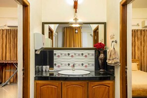 Ein Badezimmer mit Waschbecken, Spiegel und Holzausbau.