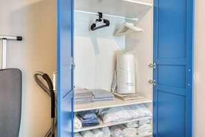A storage unit with shelves holding folded towels, pillows, and a rolled-up mattress. - Premium House, 3BR, Renovated, Best Loc Kadıköy (Kadıköy)