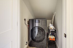A laundry room with a washing machine, a dryer, and a shelf with cleaning supplies. - Mtn-Views! Flagstaff Extended Escape Near Hiking (Flagstaff)