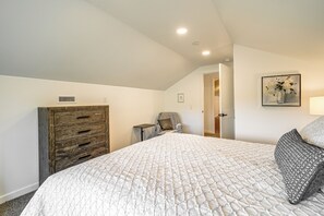 A bedroom with a large bed, a wooden dresser, a chair, and a painting on the wall. - Mtn-Views! Flagstaff Extended Escape Near Hiking (Flagstaff)