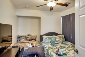 A bedroom with two beds, a ceiling fan, and a door with a handle. - Mountain-View Patio: 11 Mi to F1 Circuit (North Las Vegas)