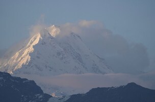 A snow-covered mountain peak with a clear sky.
