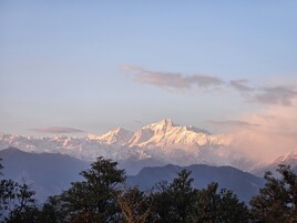 A mountain range with snow-capped peaks and a clear sky.