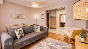 A modern living room with a grey sofa, a wooden coffee table, and a patterned rug. - Modern, 3BR, Best Location (Kadıköy)