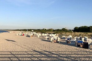 A beach with rows of beach huts and a clear sky. - Holiday apartment with 1 bedroom (Seebad Ahlbeck)