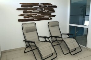 A room with two reclining chairs and a wall-mounted wooden fish decoration. - Holiday apartment with 2 bedrooms (Zinnowitz)