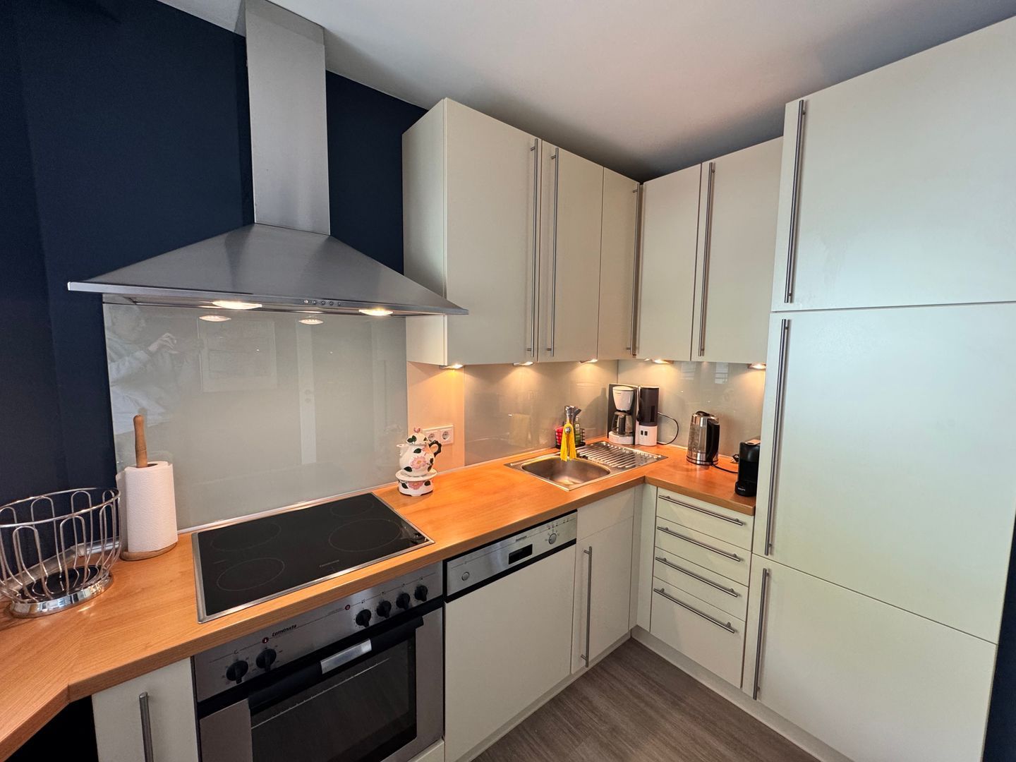 A modern kitchen with a stove, oven, and built-in dishwasher.