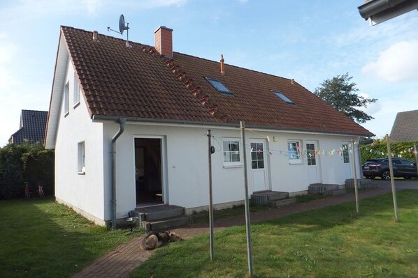 A single-story house with a sloped roof, a satellite dish, and a small porch. - 2 in Vanessa's house (Zingsst)