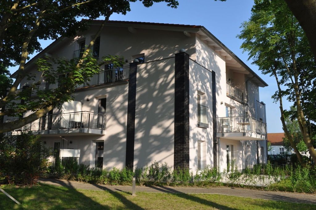 A two-story residential building with a balcony on the upper floor.