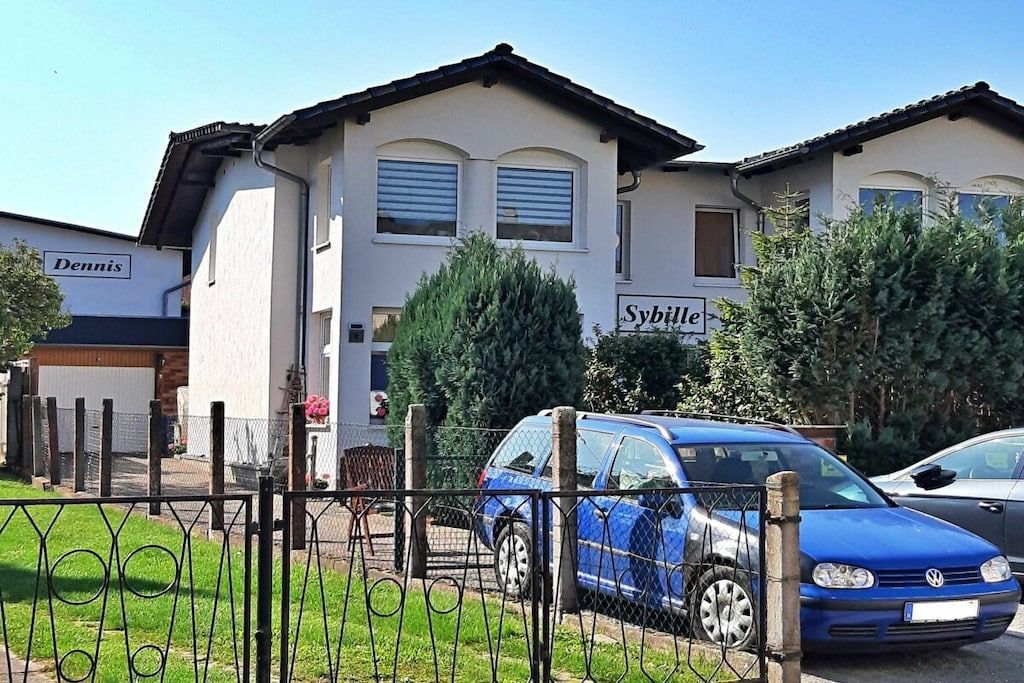 A two-story building with a sign 'Dennis' on the left and 'Sybil' on the right.
