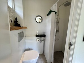 A compact bathroom with a toilet, sink, and shower. - Holiday Home in Bergen With Swimming Pool (Bergen)