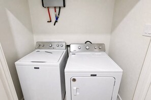 A laundry room with two Maytag washing machines and a utility wall with electrical outlets. - King Bed-Unbeatable Location-Bishop Arts- Unit 3 (Dallas)