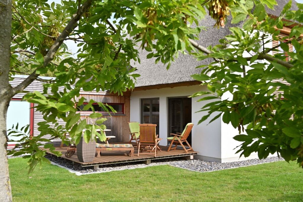 A house with a patio area featuring outdoor furniture.