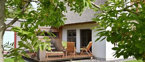 A house with a patio area featuring outdoor furniture.