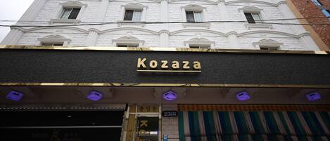 A building with a sign reading 'Kozaza' and a sign for a motel.
