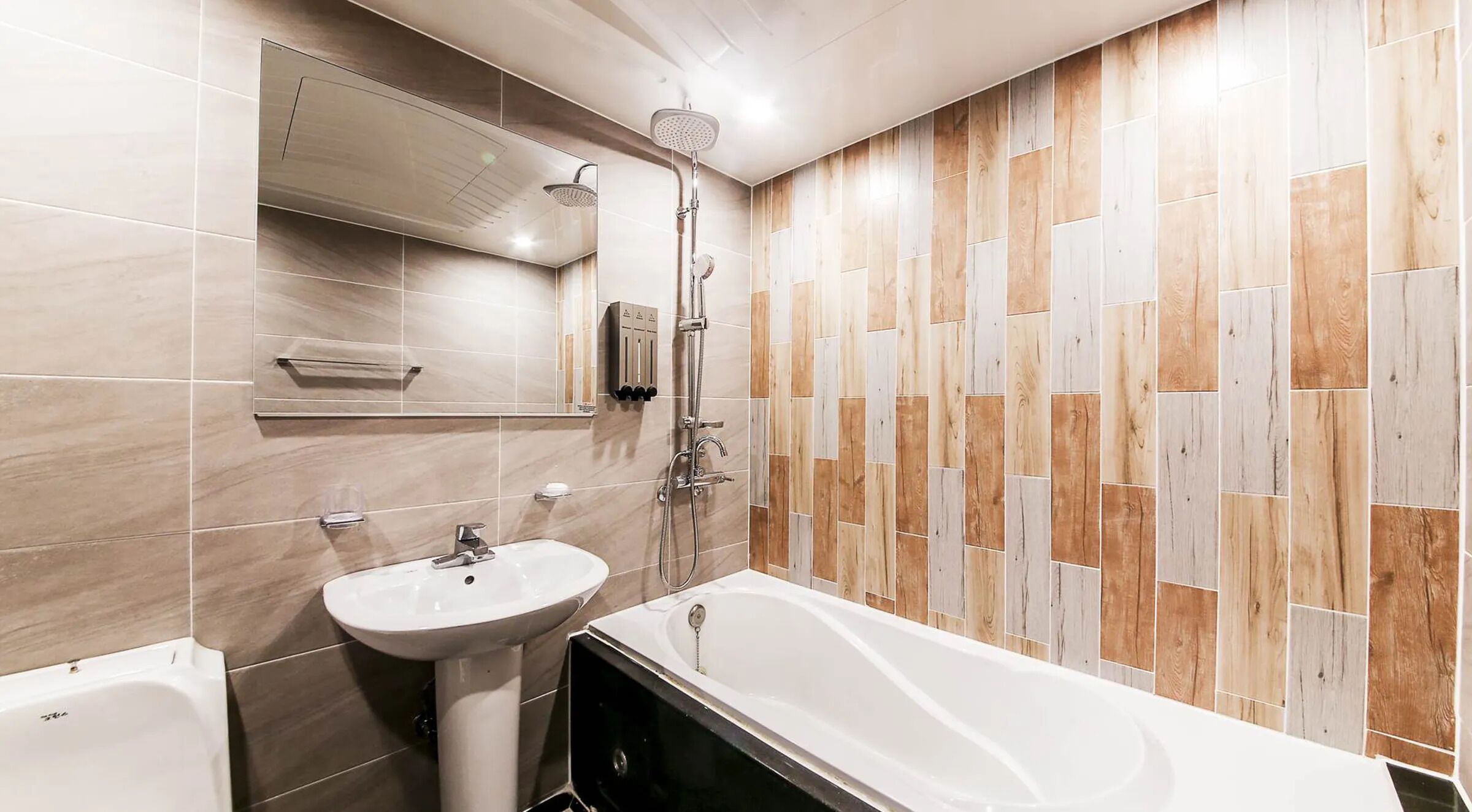 A bathroom with a bathtub, a sink, and a shower.