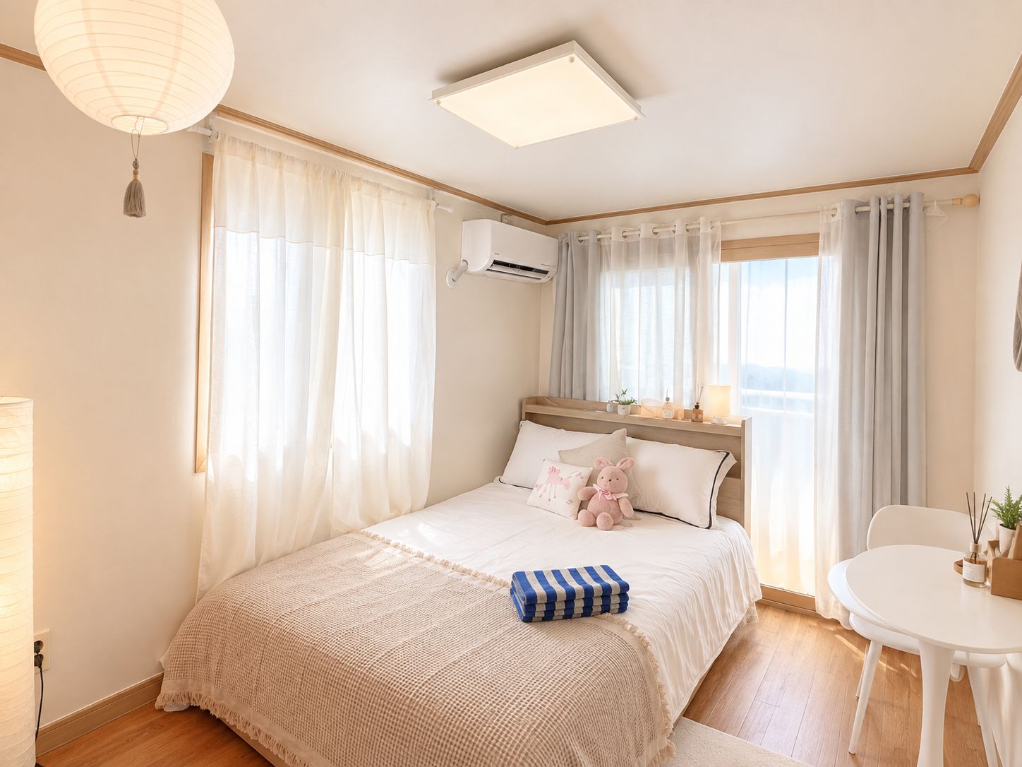 A bedroom with a bed, a bedside table, a chair, and a window with curtains.