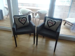Two dark-colored chairs with heart-shaped pillows featuring reindeer silhouettes. - Mühlehof D4 Appartement/Fewo, Dusche oder Bad, WC 4 1/2-Zimmerwohnung by Interhome (Davos)