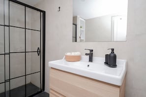 A bathroom with a white sink, black faucet, and a mirror above it. - Spacious 4BR Private Townhouse with Exclusive Terrace (İstanbul)
