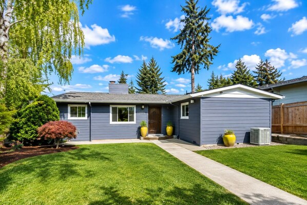 A residential house with a front yard, a driveway, and a mailbox.