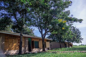 A traditional wooden house with a porch and a sign reading 'HYENA HOUSE'. - Basecamp Resort Mweya (Mweya)