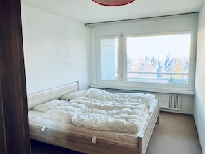 A bedroom with a single bed, a window, and a radiator. - Apartmenthaus Gauenpark (CharmingStay), (Flumserberg Tannenheim), by Interhome (Flumserberg Tannenheim)